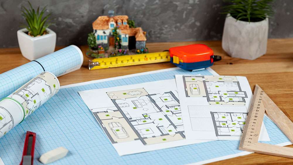 Home repair project documents and tools on a desk