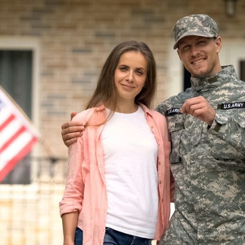 Soldier and wife showing keys to their new home.